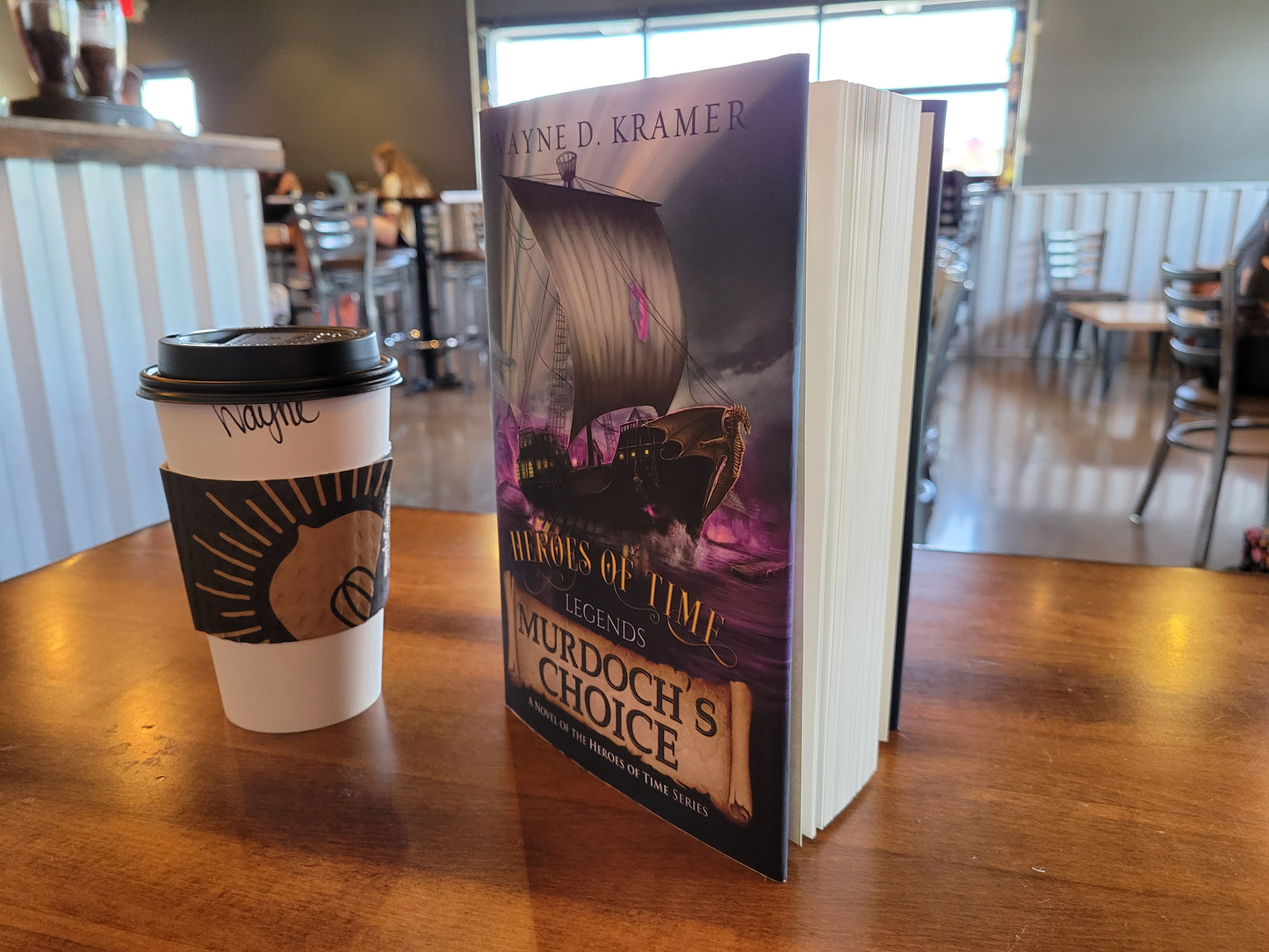 Murdoch's Choice hardcover on display at coffee shop